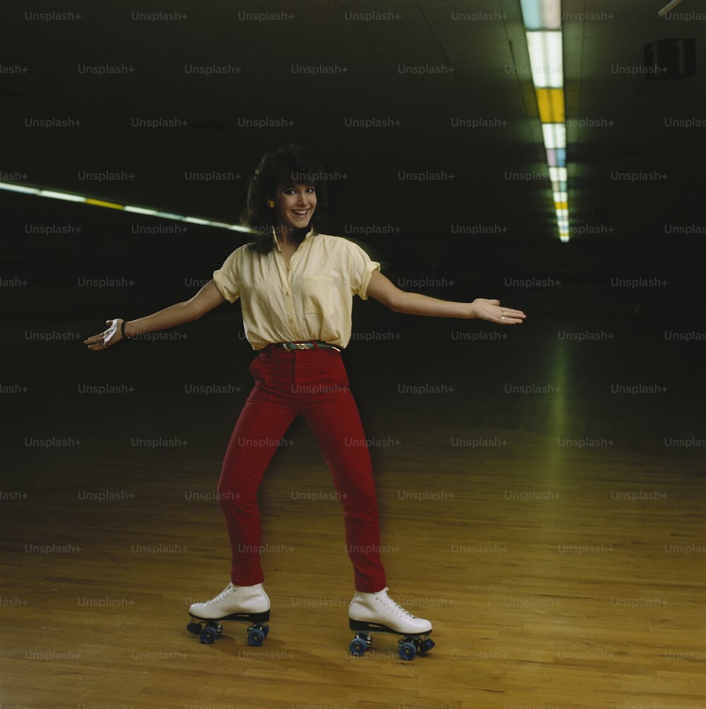 a man riding a skateboard on top of a wooden floor