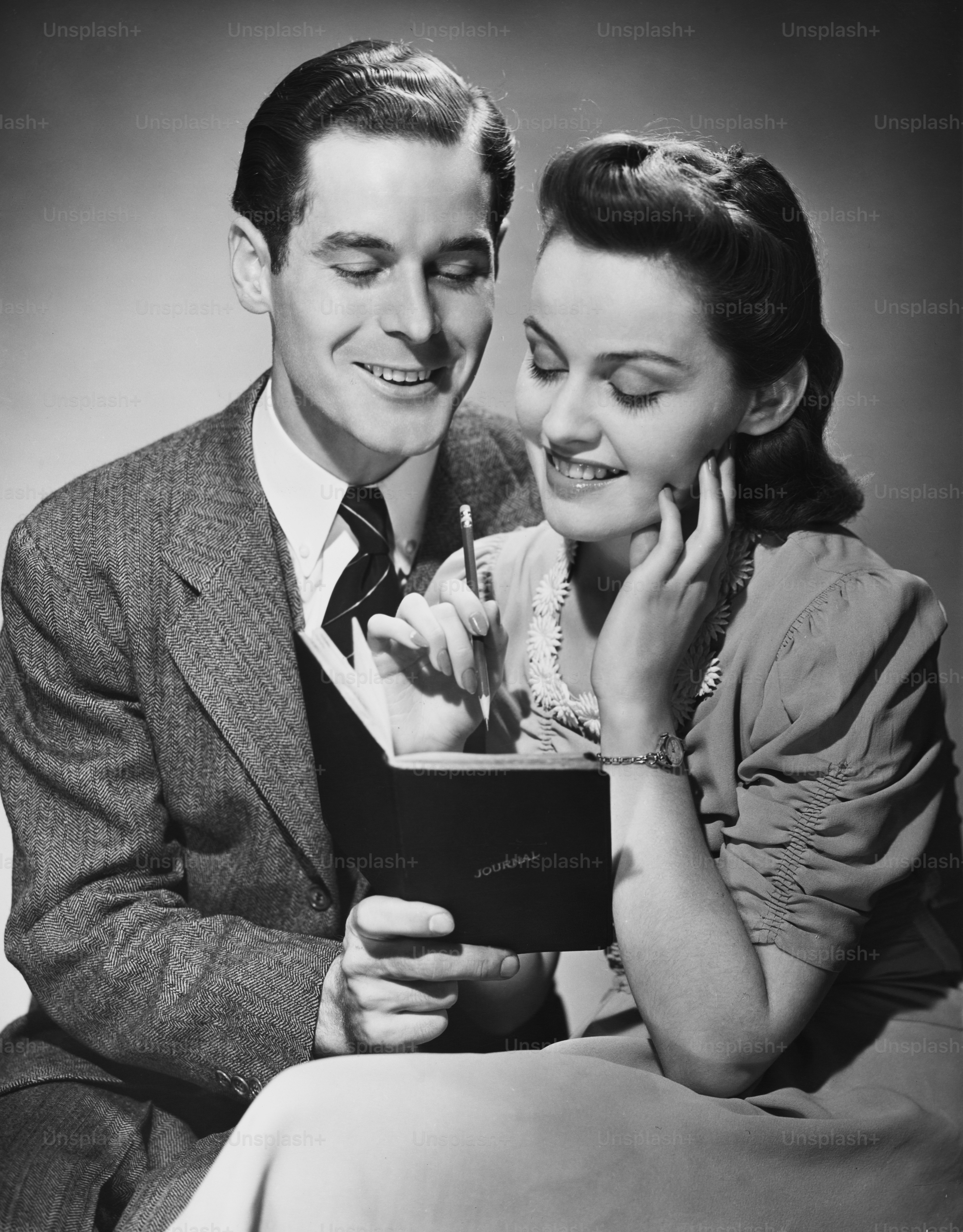 A young couple smiling over an entry in a journal, circa 1940.  (Photo by George Marks/Retrofile/Getty Images)