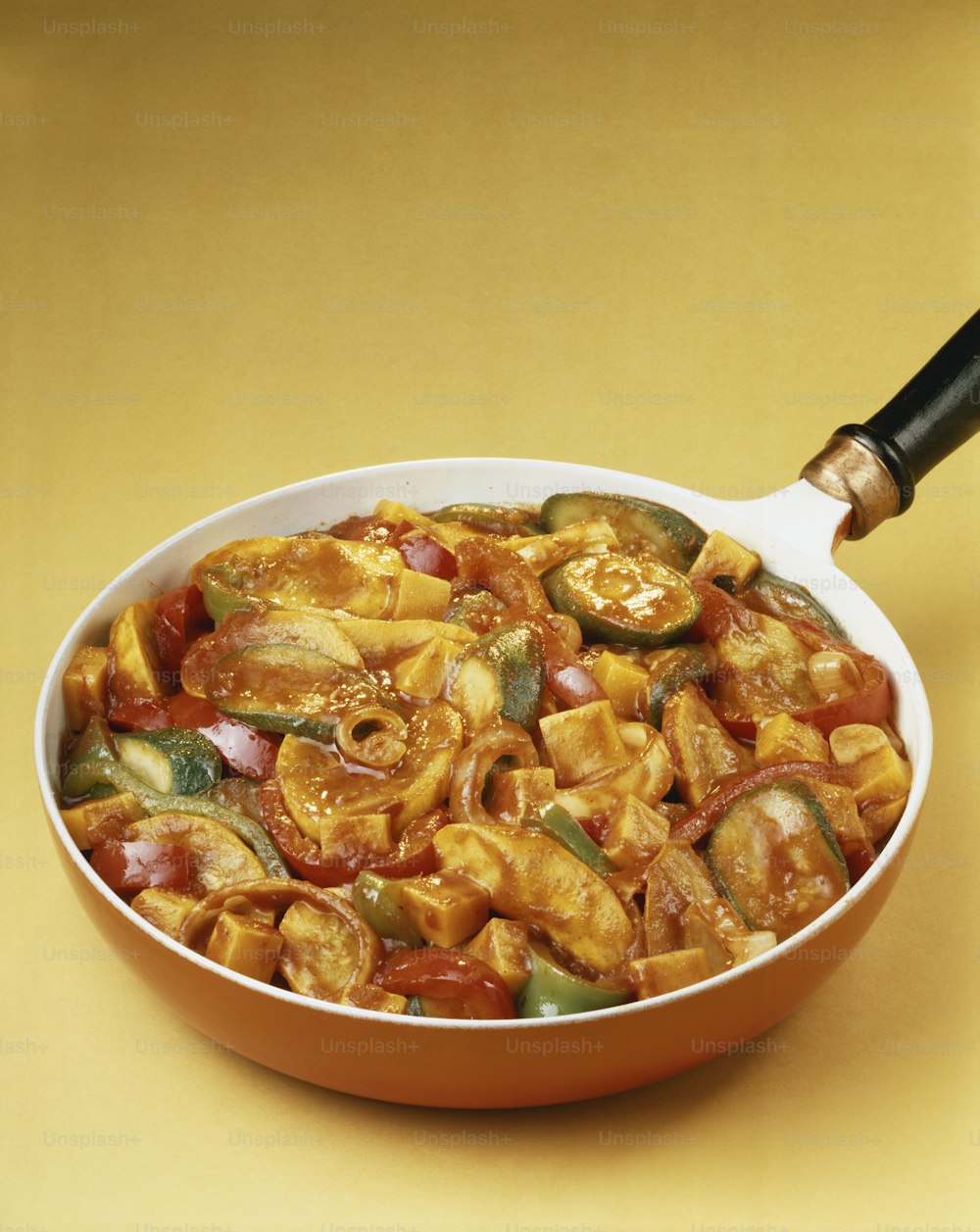 a pan filled with pasta and vegetables on a table