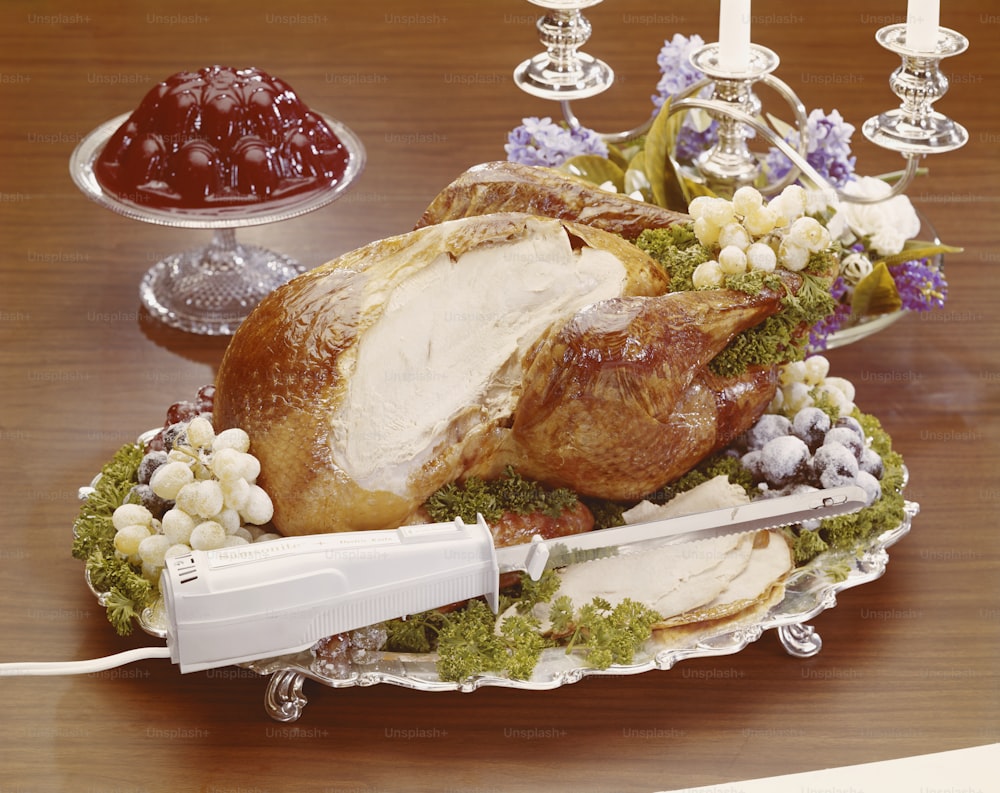 a turkey on a platter with a knife on a table