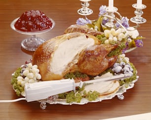 a turkey on a platter with a knife on a table