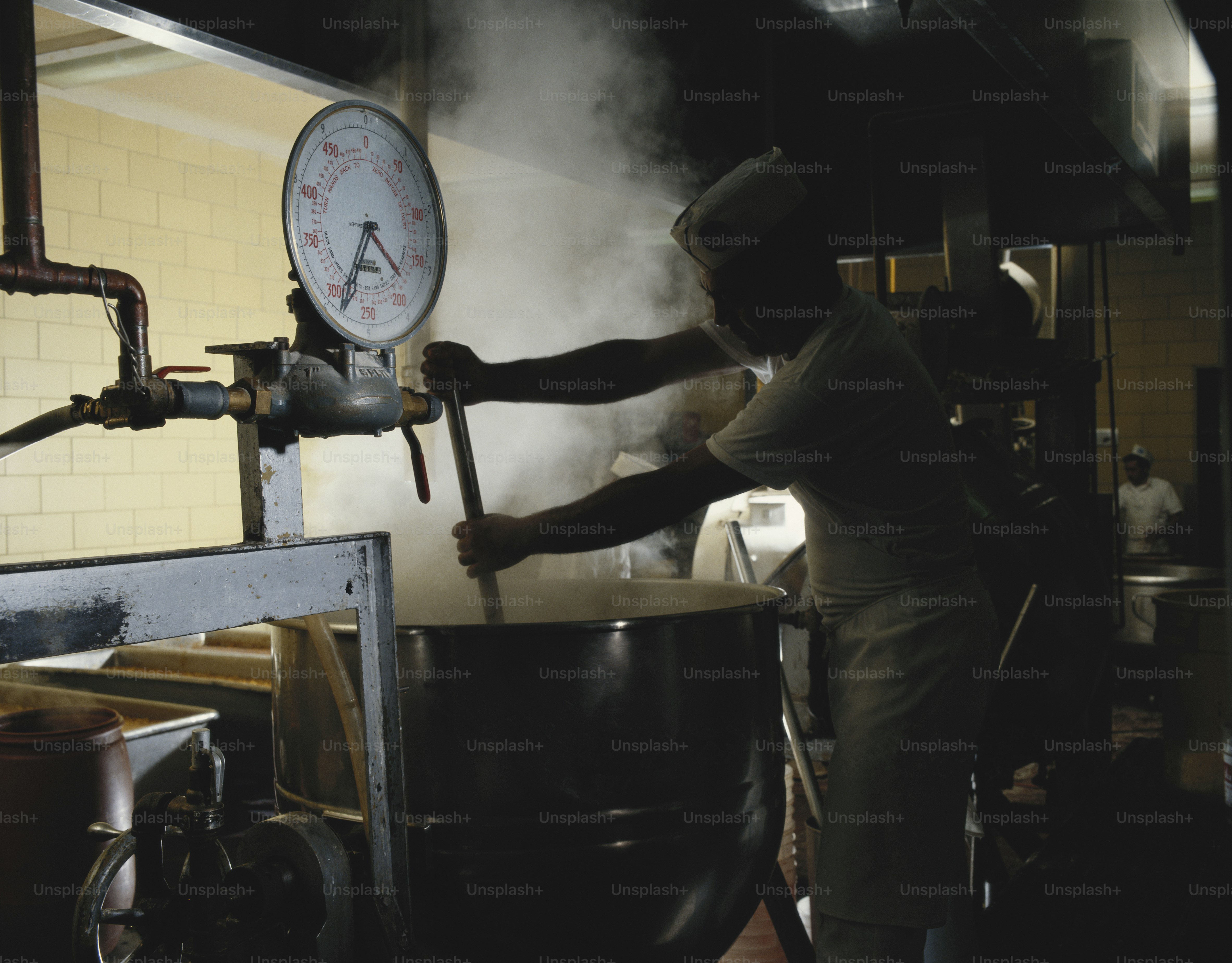 a man is cooking in a large pot