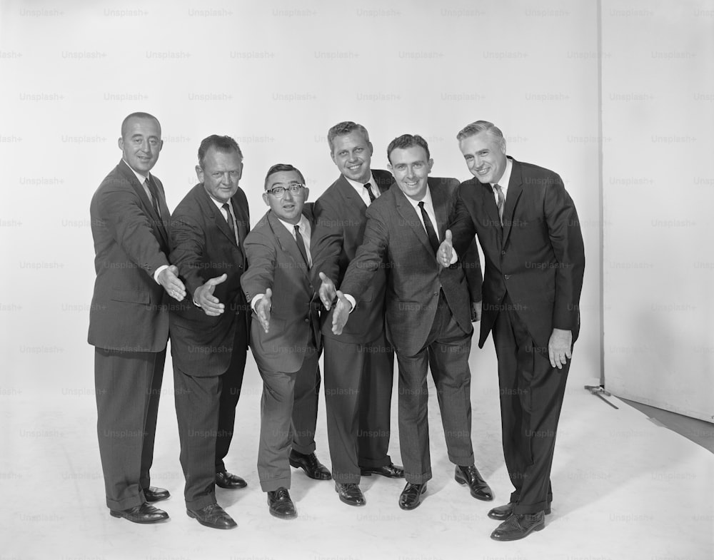 a group of men in suits posing for a picture