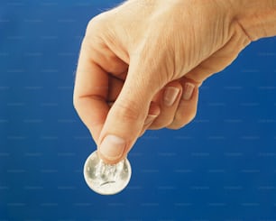 a person holding a coin in their hand
