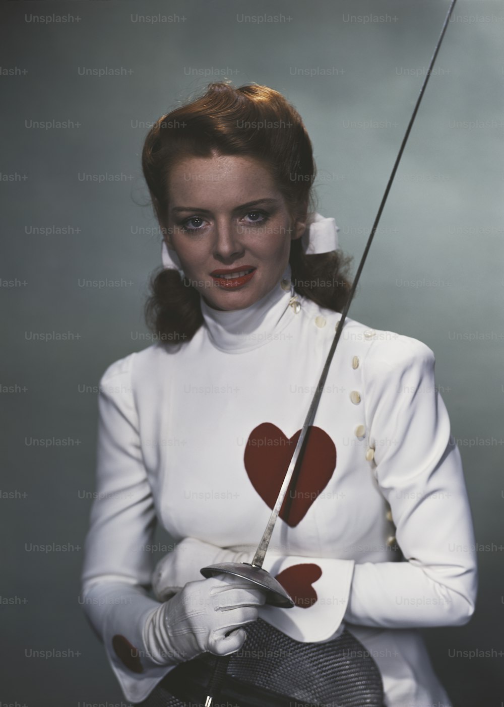 a woman holding a golf club with a heart on it