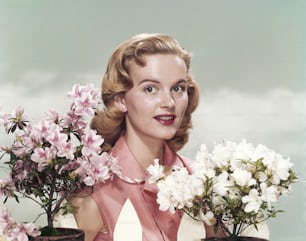 a woman is holding a bunch of flowers
