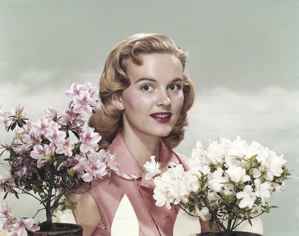 a woman is holding a bunch of flowers