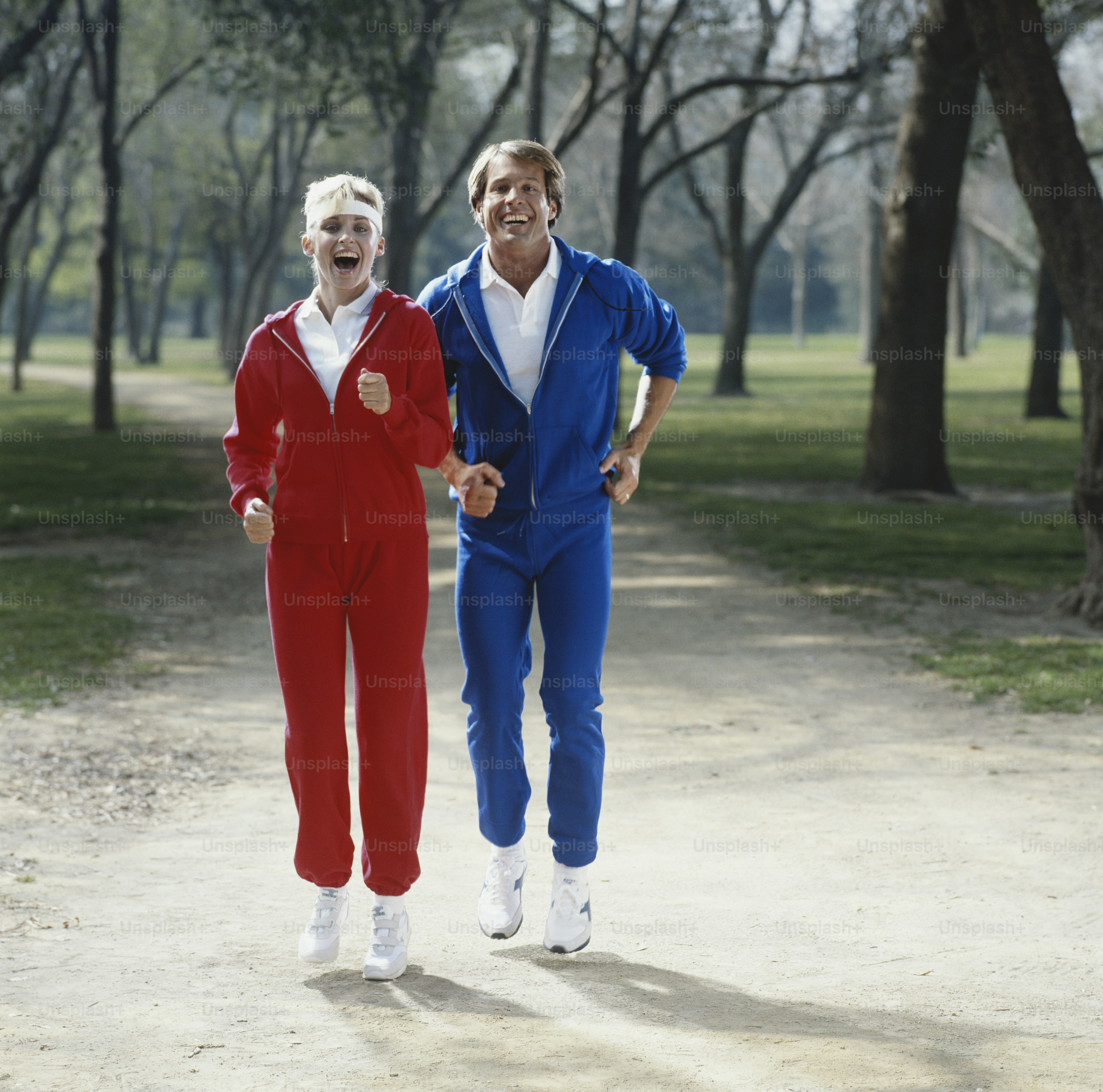 a couple of people that are walking down a dirt road