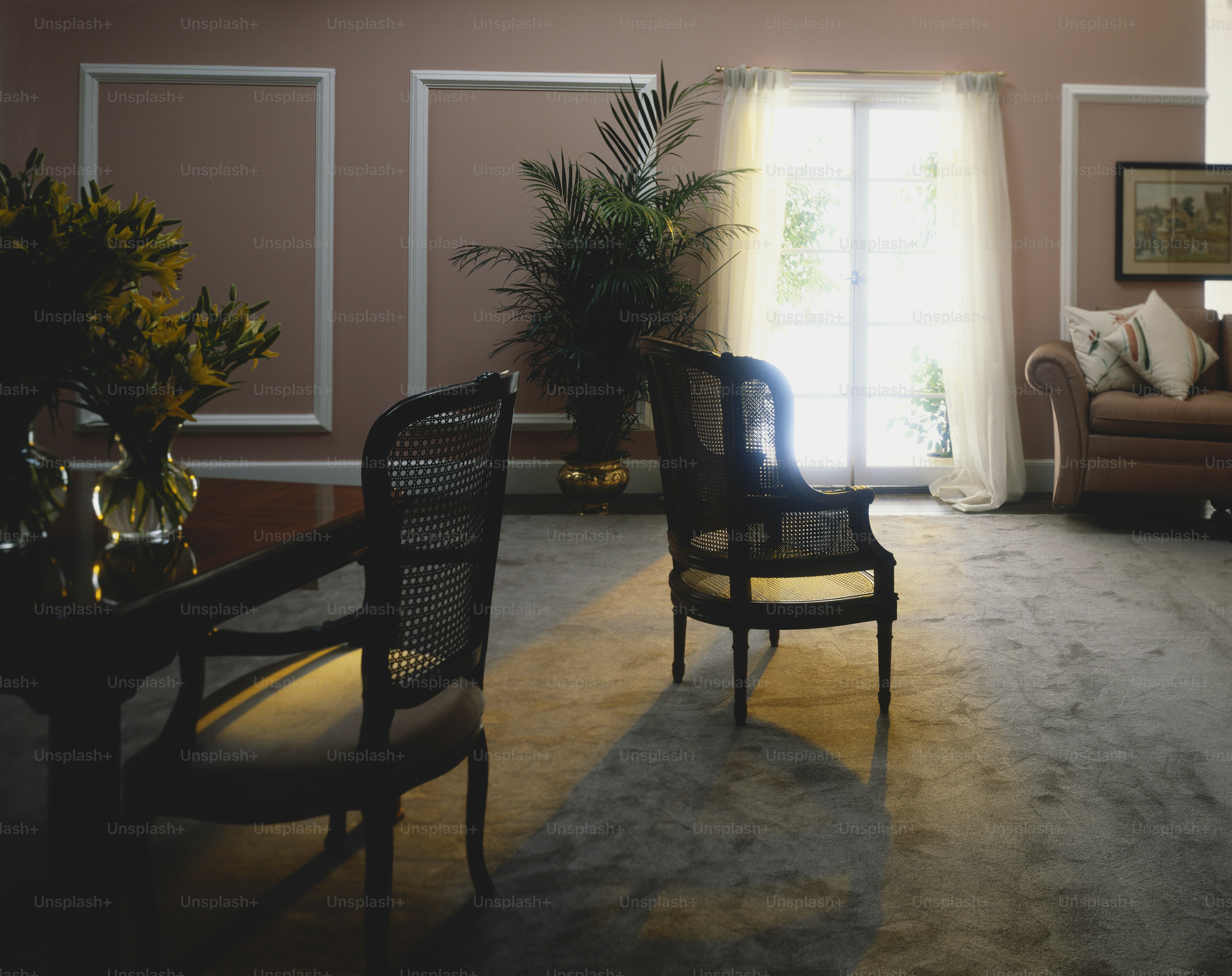 a living room filled with furniture and a large window