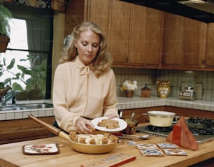 a woman sitting at a kitchen counter with a plate of food