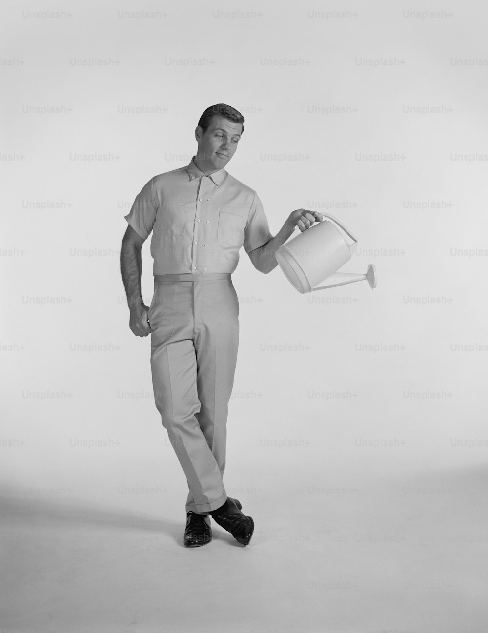 a man is holding a bucket and posing for a picture
