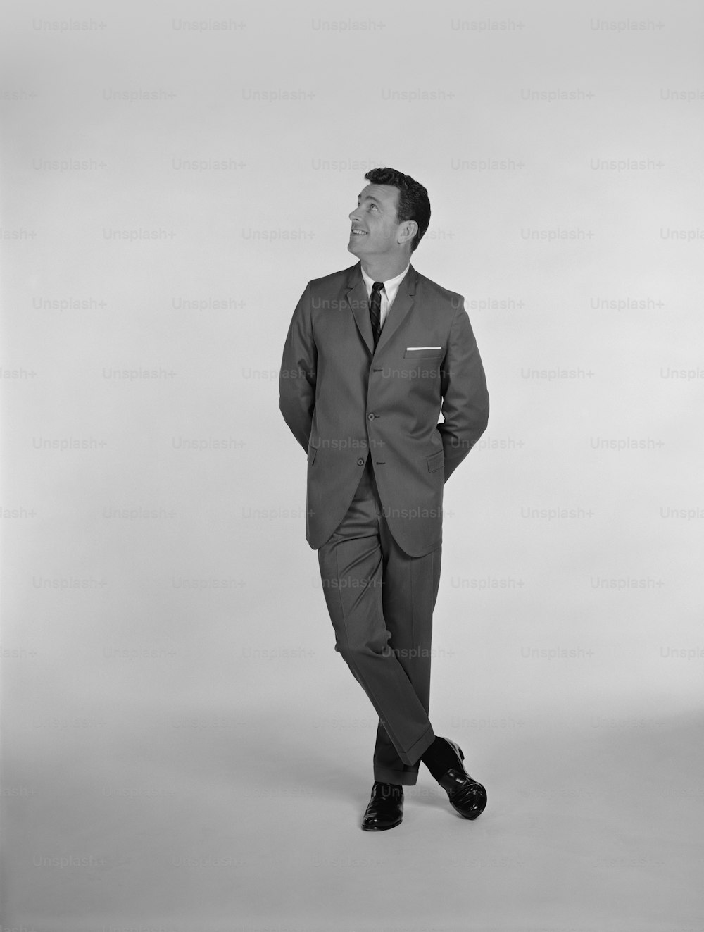 a black and white photo of a man in a suit