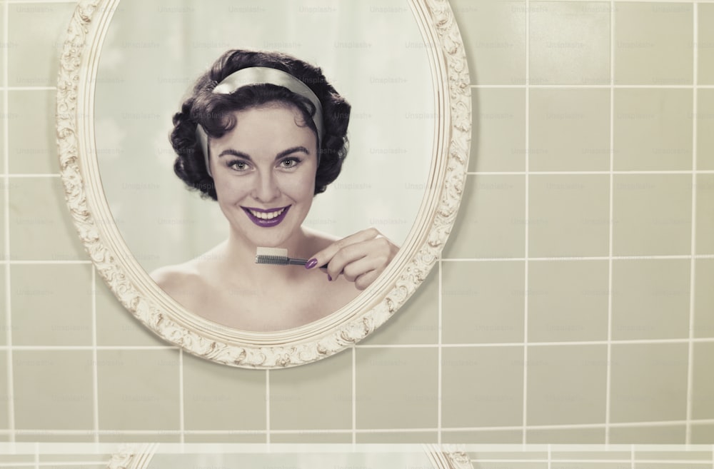 a woman brushing her teeth in front of a mirror