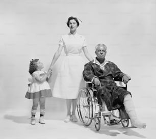 an old photo of a man in a wheelchair with a little girl