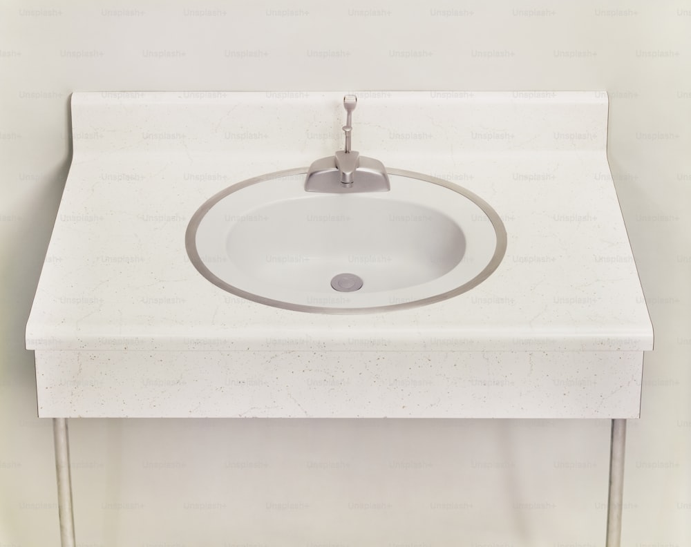 a white bathroom sink with a chrome faucet