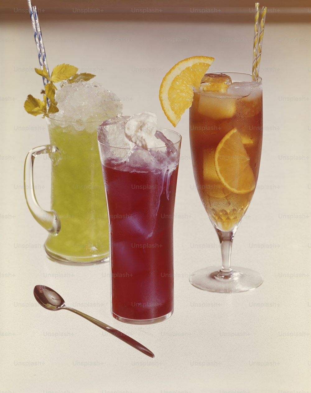 three different types of drinks on a table