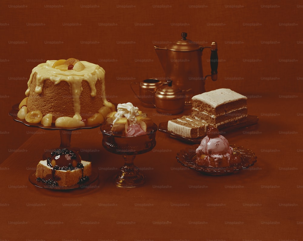 a table topped with cakes and desserts on top of a table