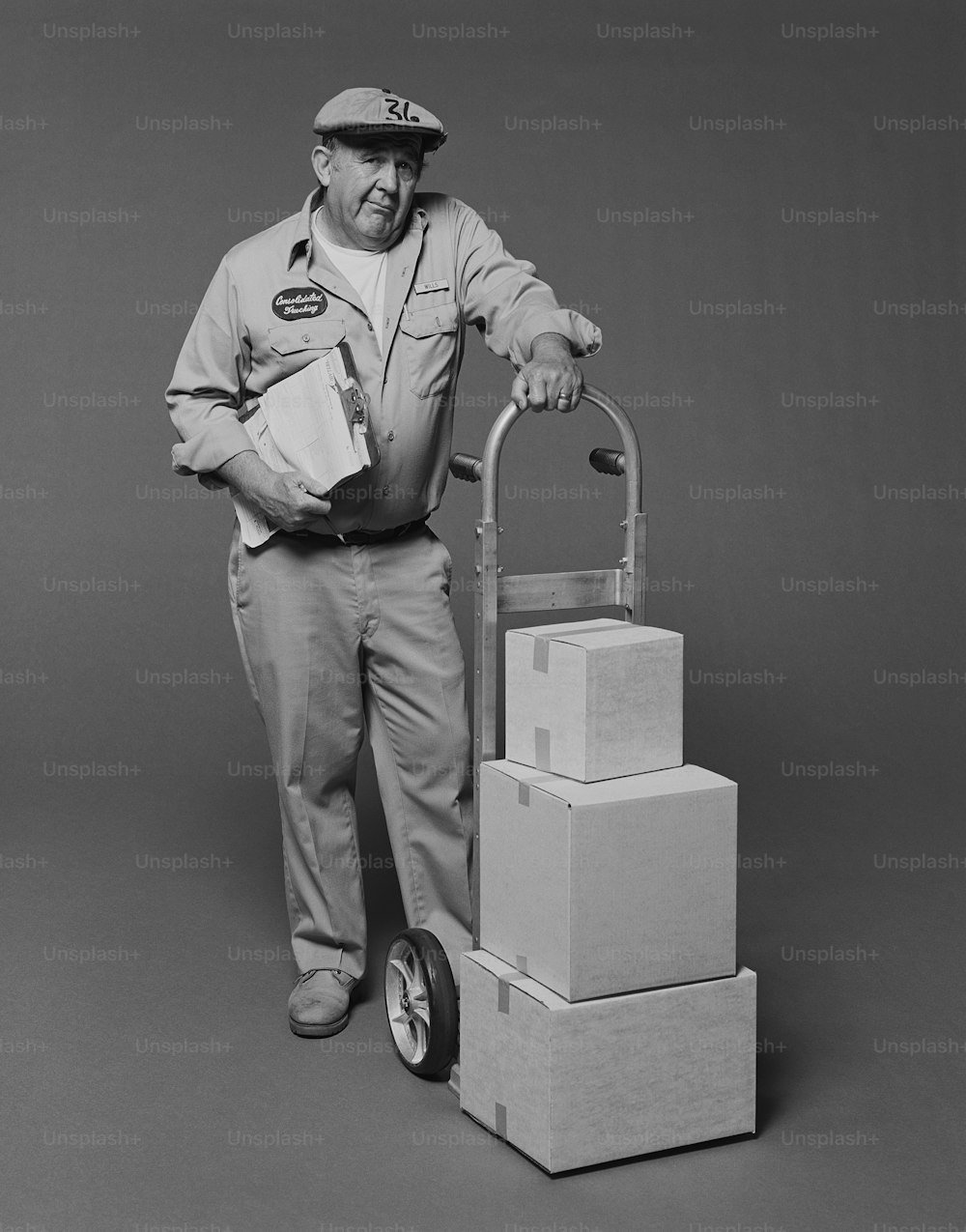 a man standing next to a stack of boxes