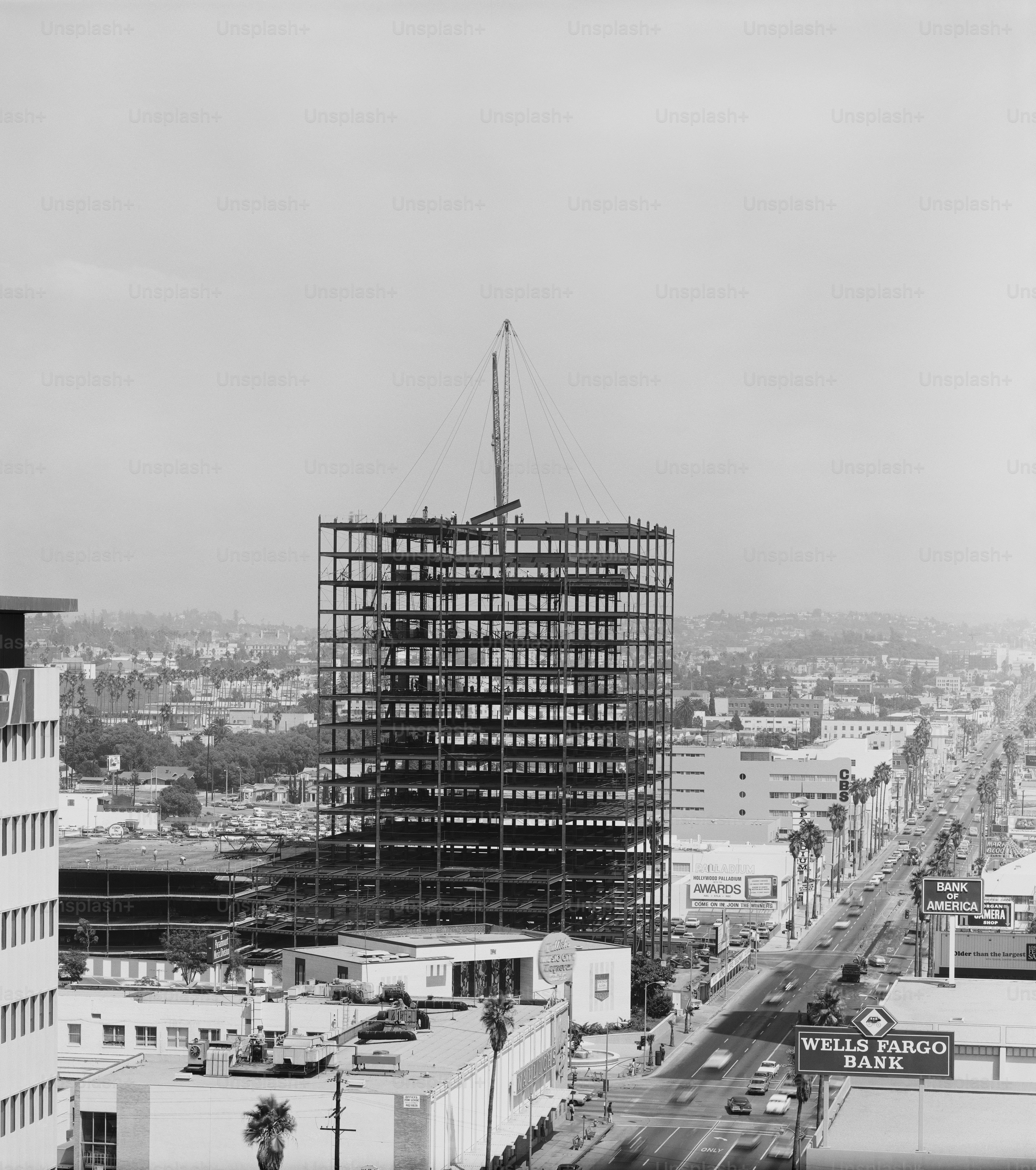 a black and white photo of a building under construction