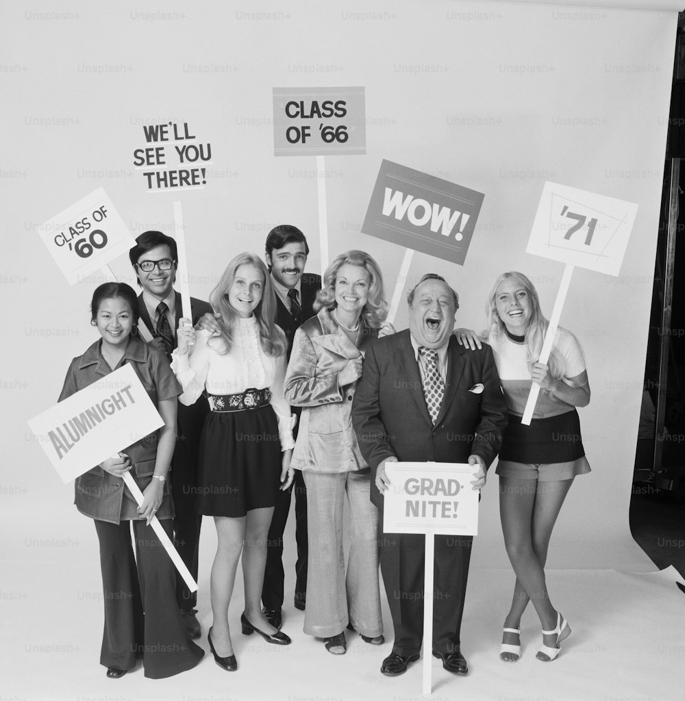 a black and white photo of a group of people holding signs