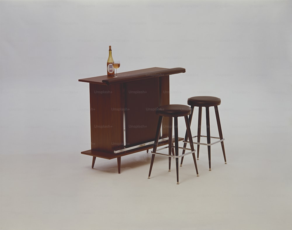 a bar with three stools and a bottle of beer