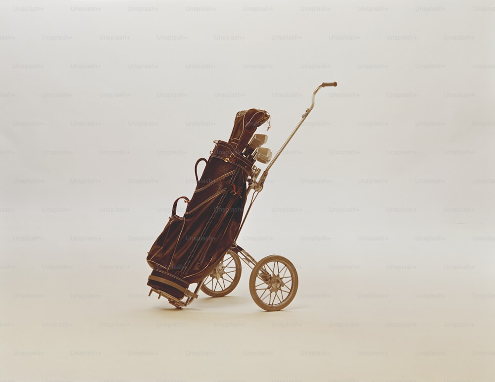 a doll in a stroller with a bag on it