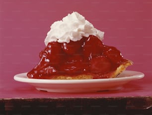 a piece of pie with whipped cream on top