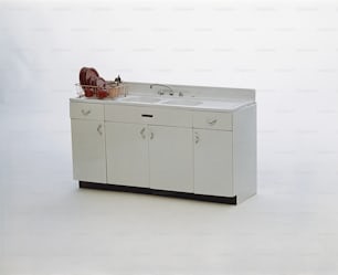 a white sink sitting on top of a white counter