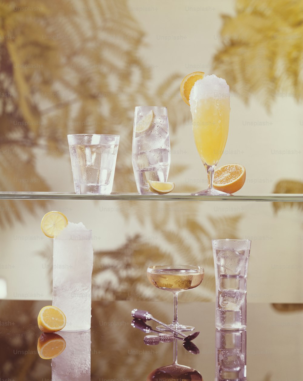 a table topped with glasses filled with different types of drinks