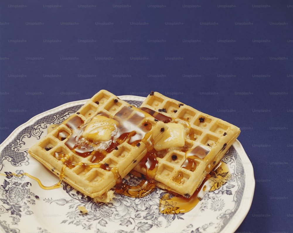 a plate with waffles and syrup on it