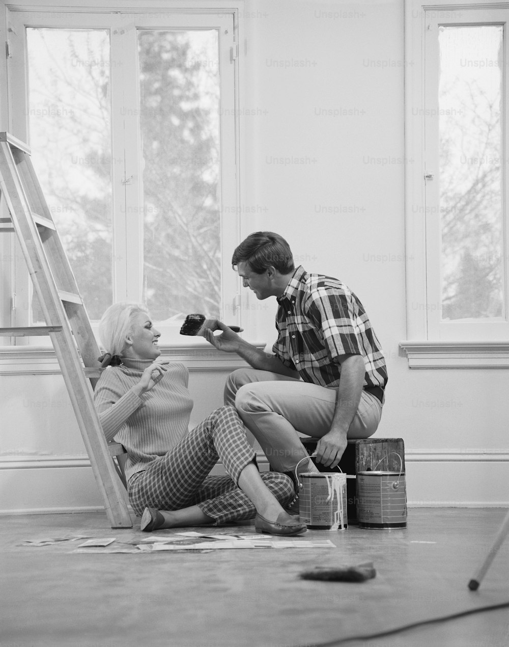a man and a woman sitting on a step ladder