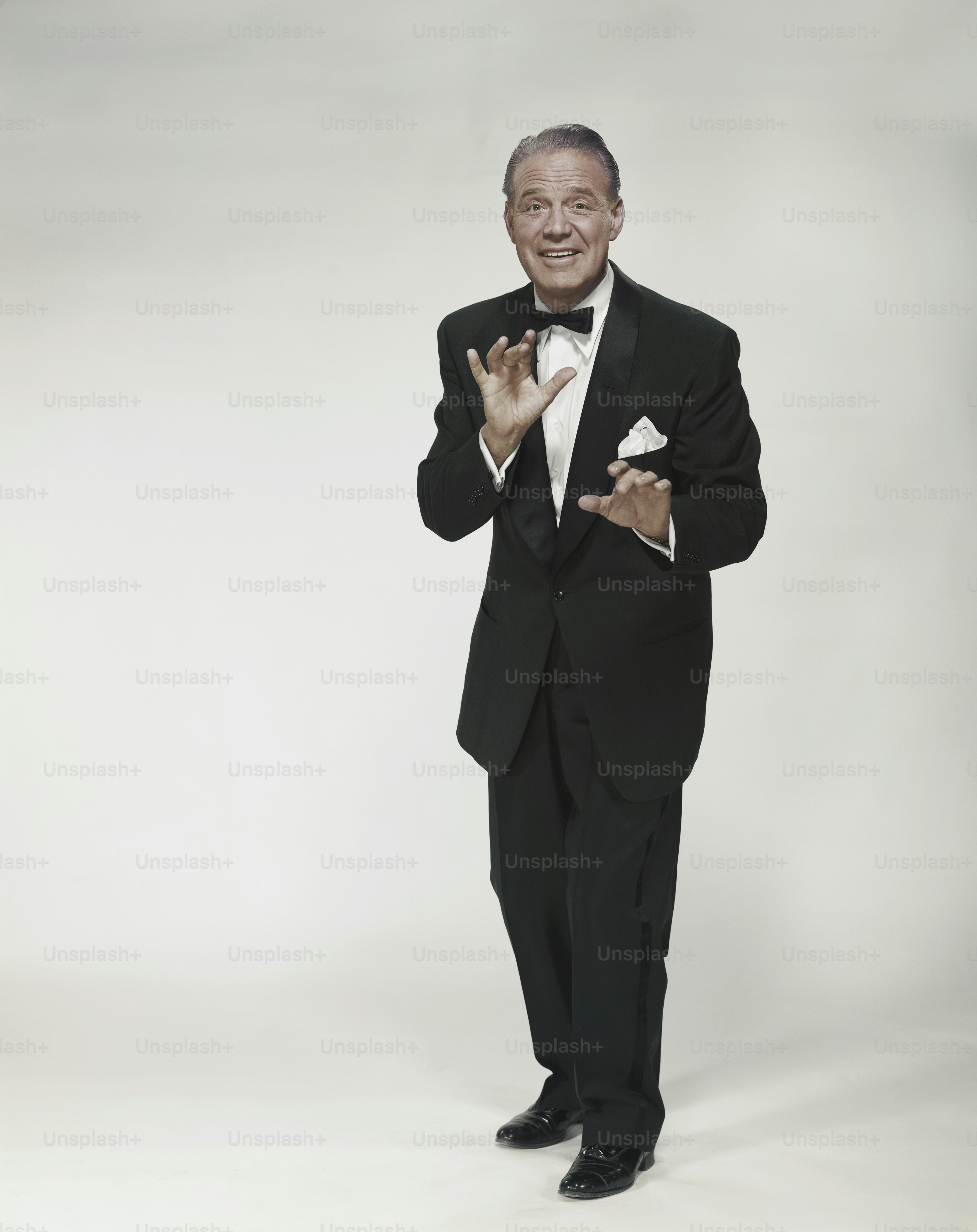 a man in a tuxedo posing for a picture