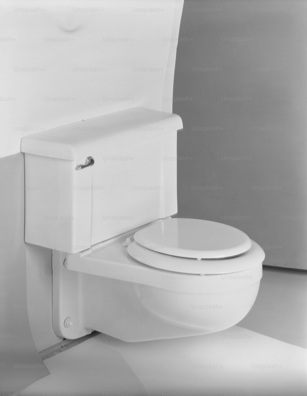 um vaso sanitário branco sentado ao lado de uma parede