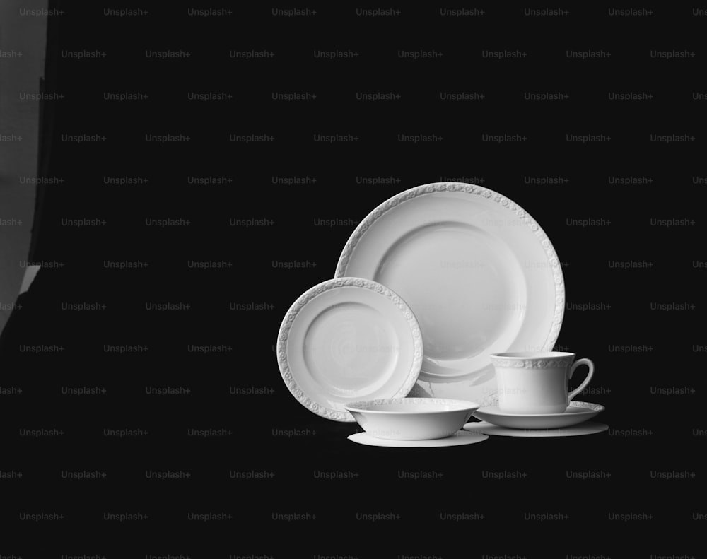 a black and white photo of a set of dinnerware