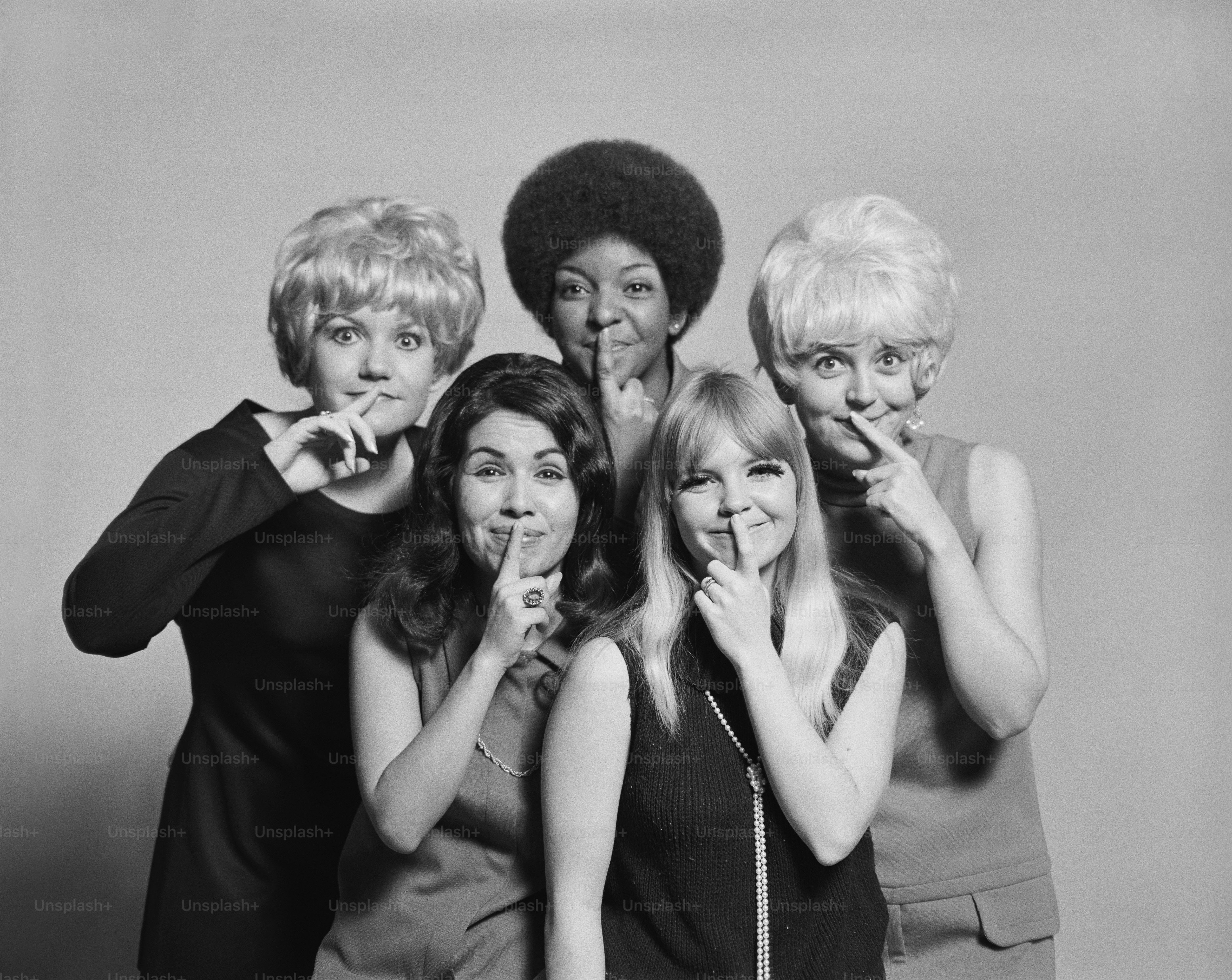 a black and white photo of a group of women