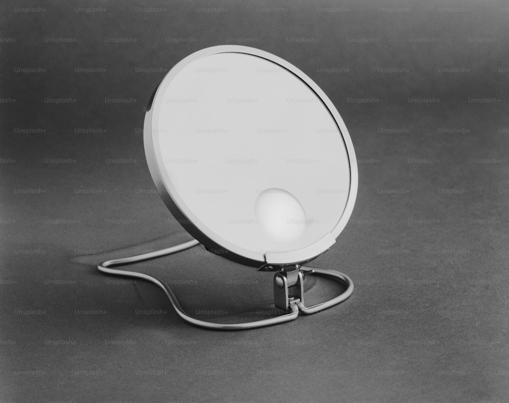 a white light sitting on top of a metal stand