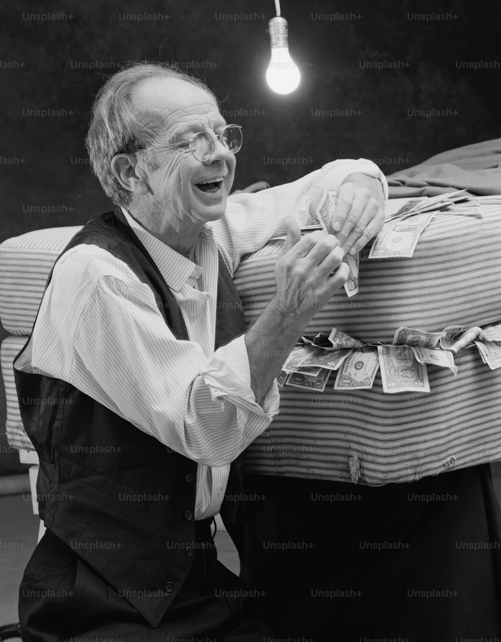 a man sitting on the ground with money in his hands