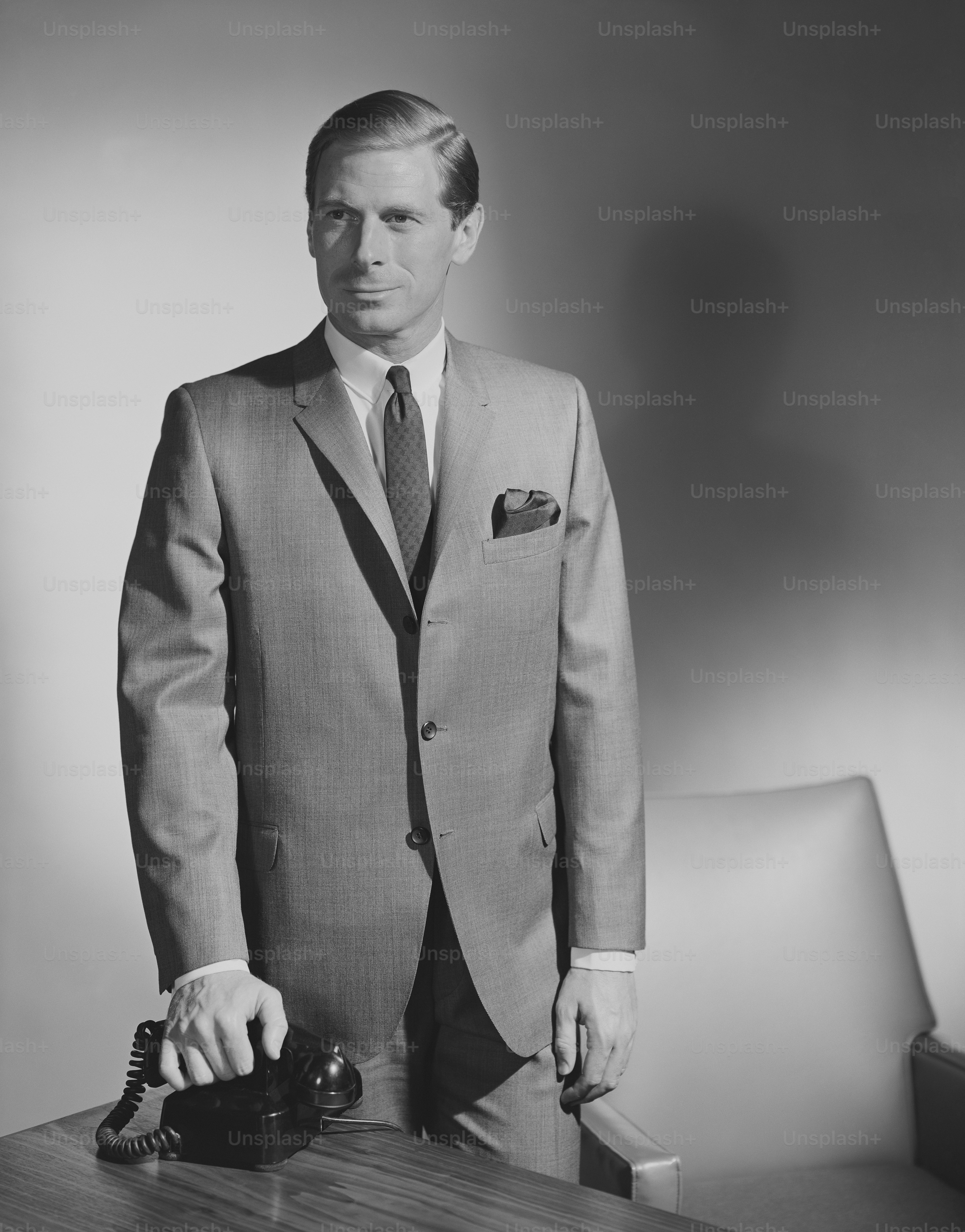 a black and white photo of a man in a suit