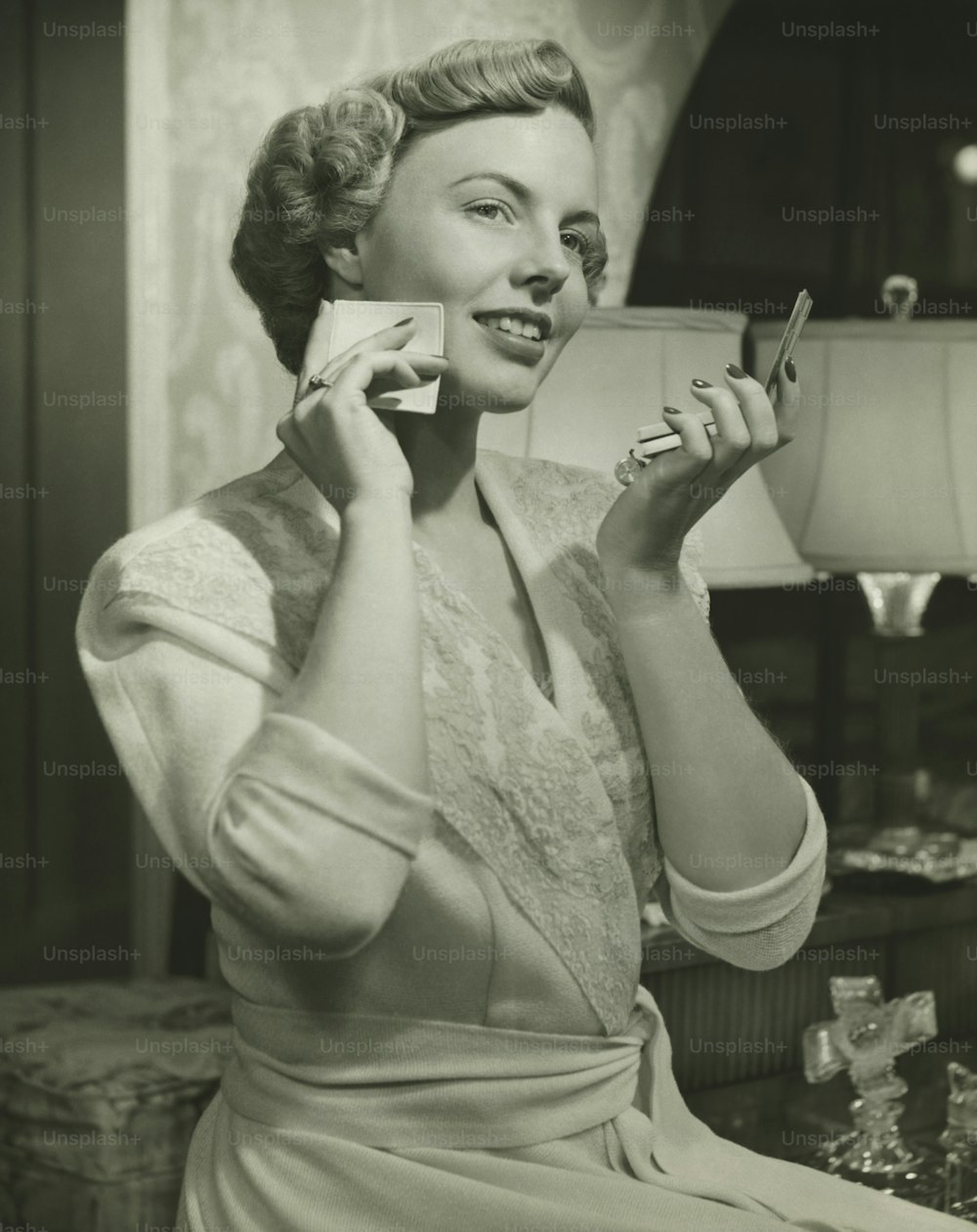 a woman holding a cup and a cell phone