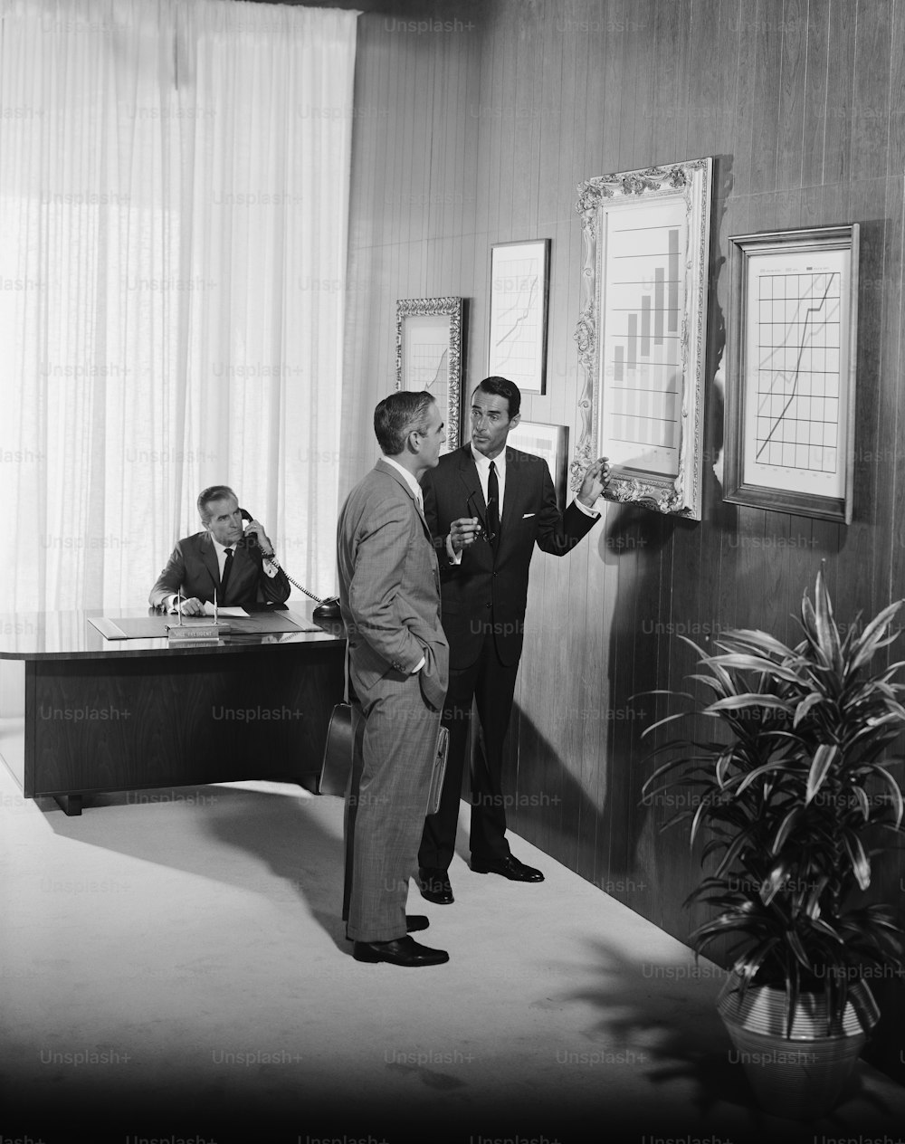 a couple of men standing next to each other in a room