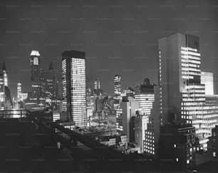 a black and white photo of a city at night