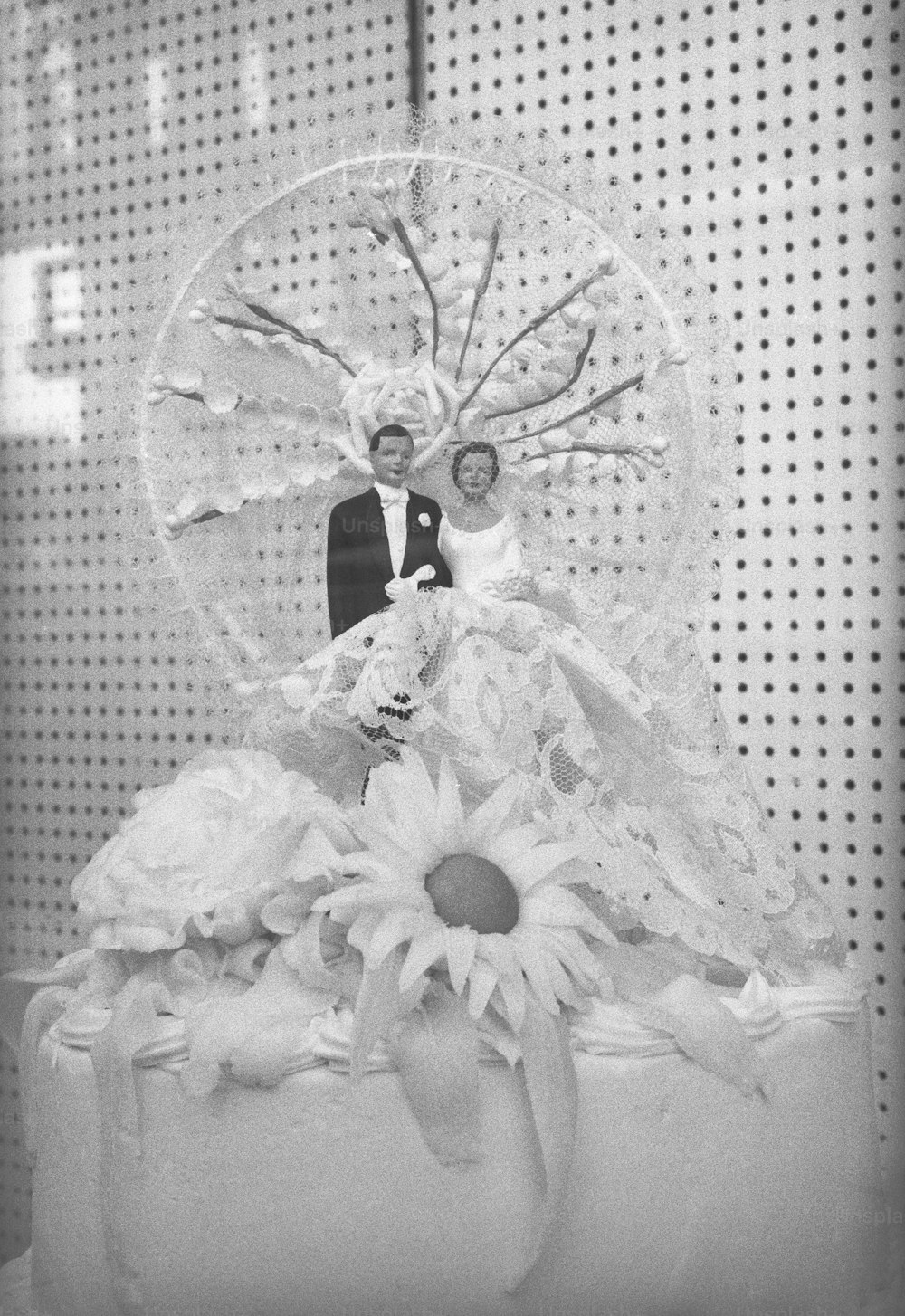 a wedding cake with a bride and groom on top