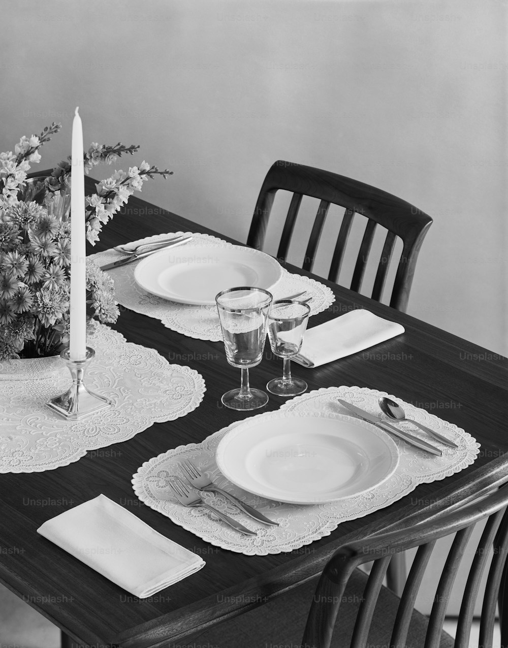 a black and white photo of a dining table
