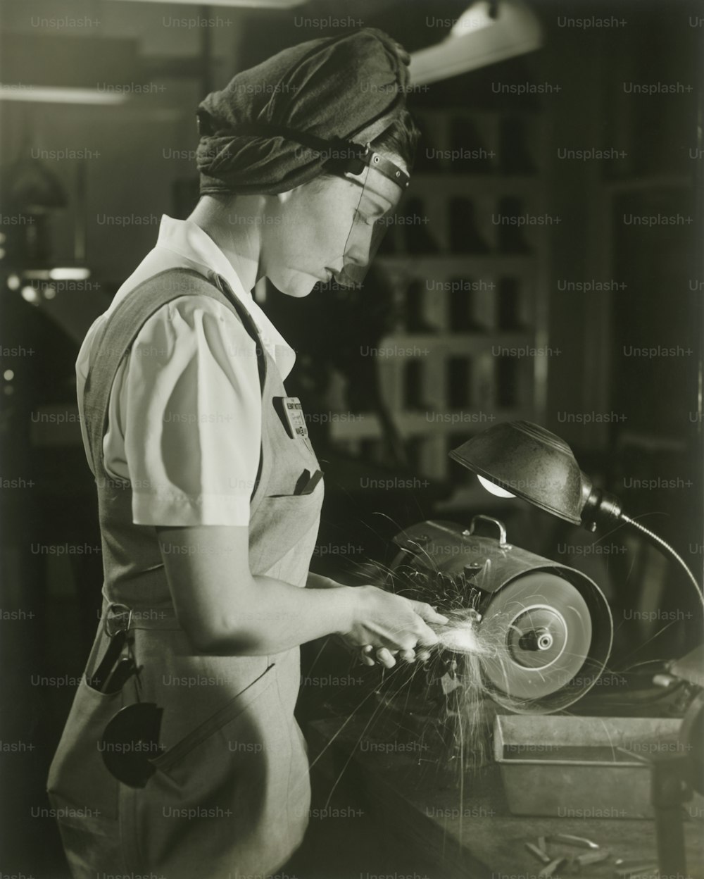 a woman working on a machine in a factory