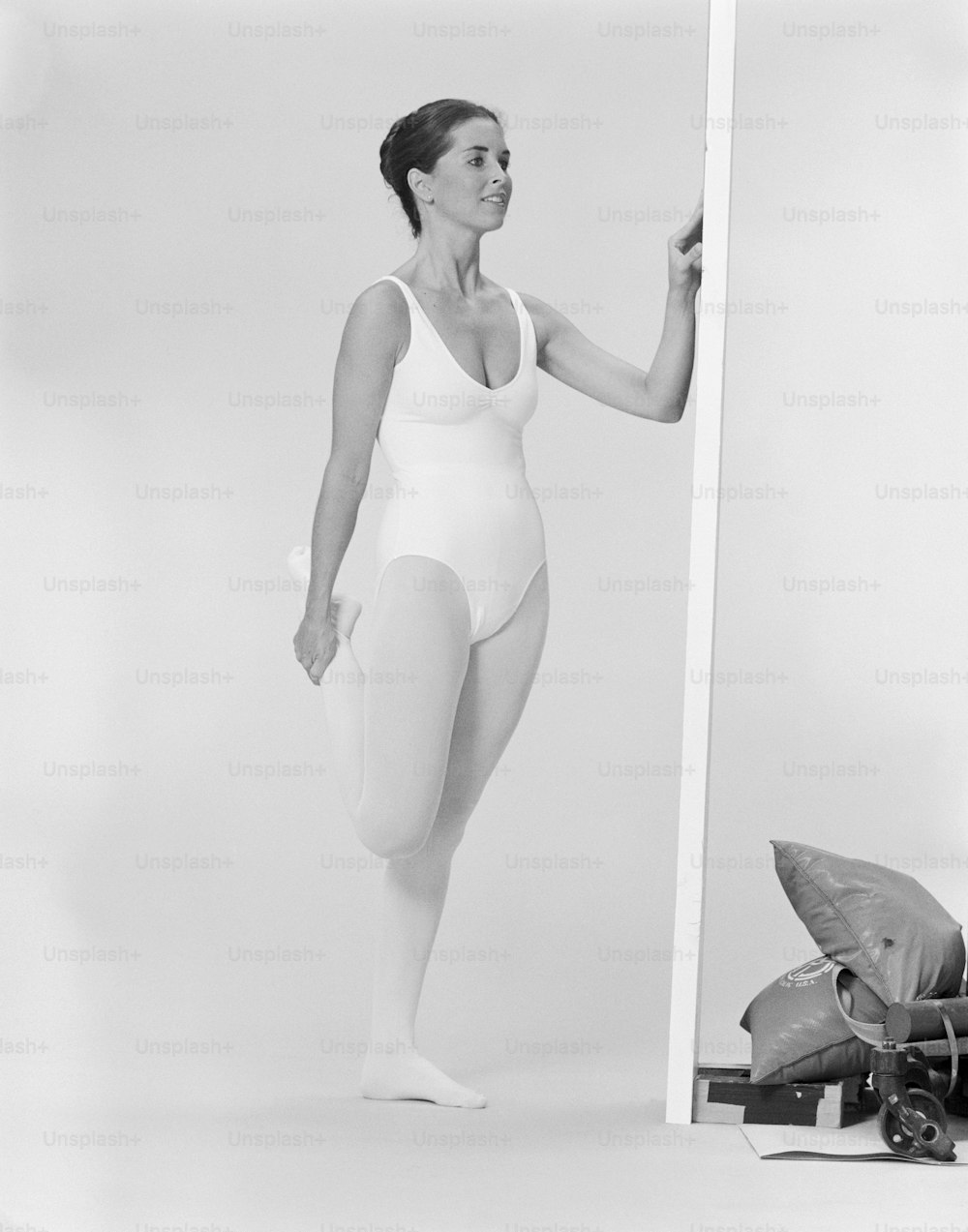 a black and white photo of a woman in a bathing suit