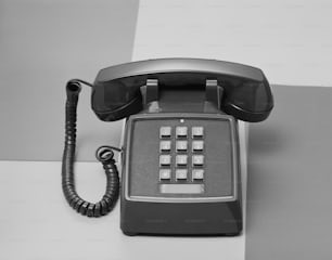 an old style phone sitting on top of a table