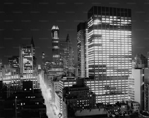 a black and white photo of a city at night