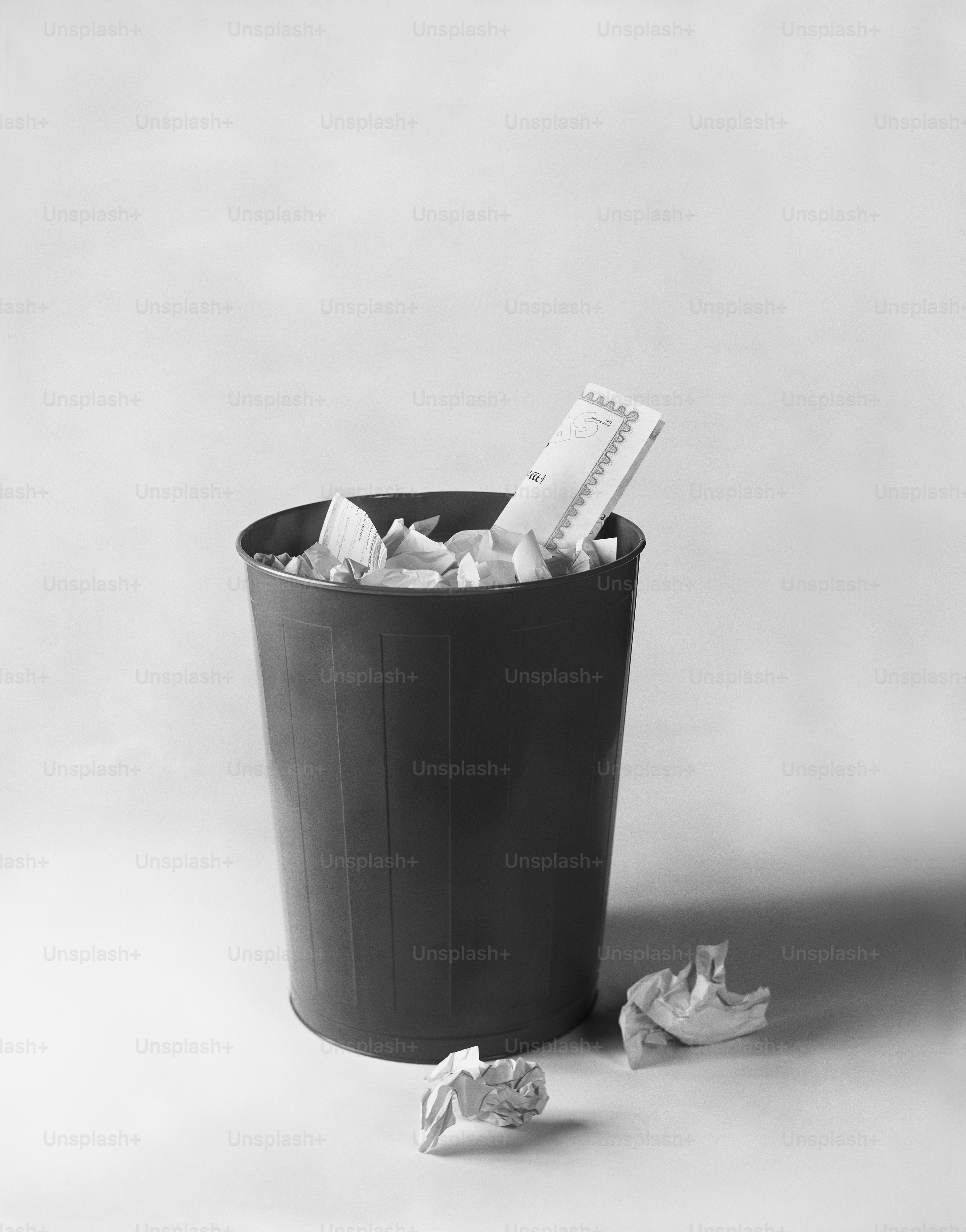 a black and white photo of a trash can