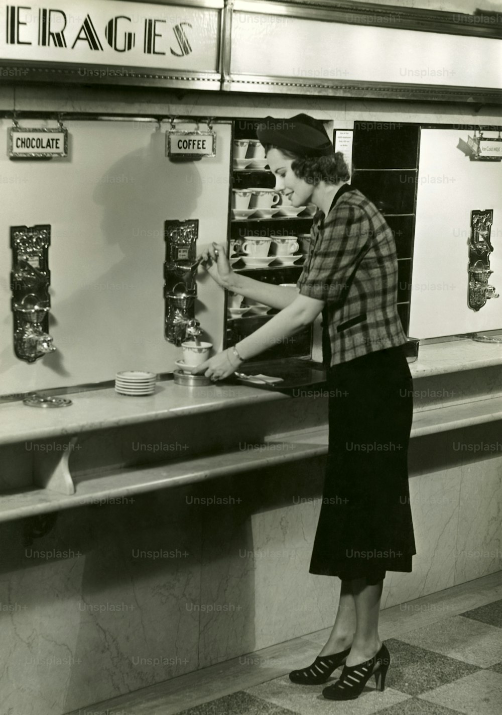 UNITED STATES - CIRCA 1950s:  Woman getting coffee.