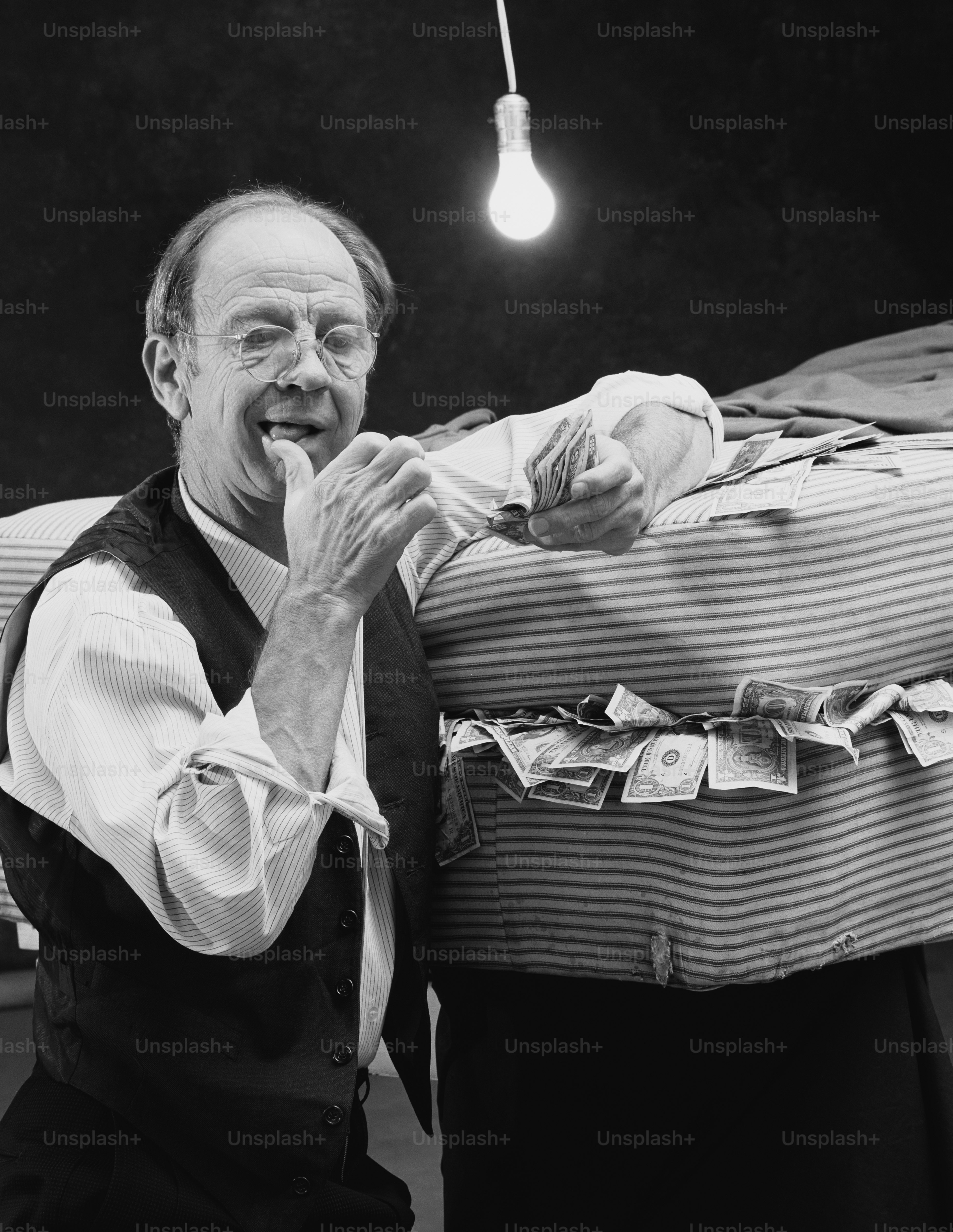 a black and white photo of a man holding a baby
